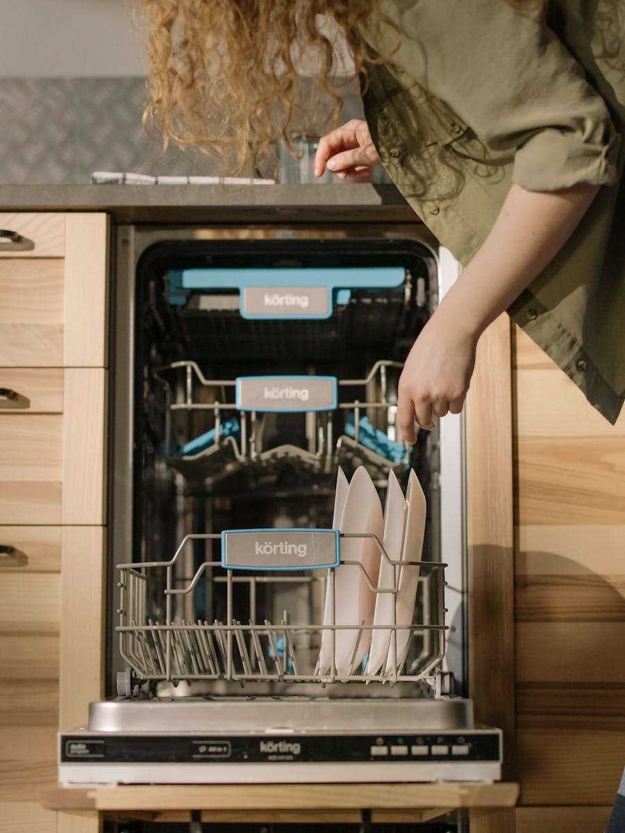 Open dishwasher with clean dishes on the lower rack