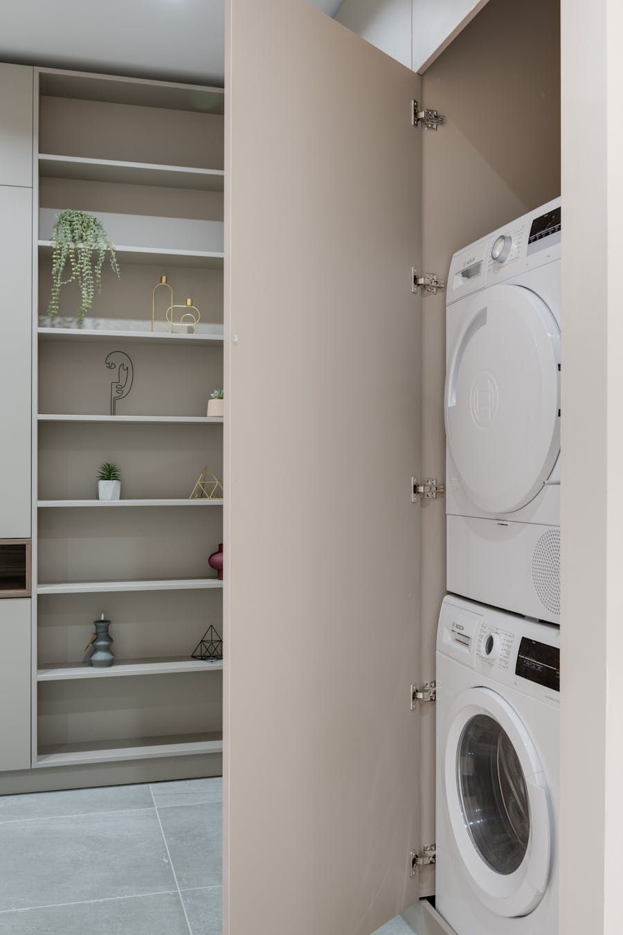 Stacked front-load dryer and washer installed in a built-in laundry cabinet