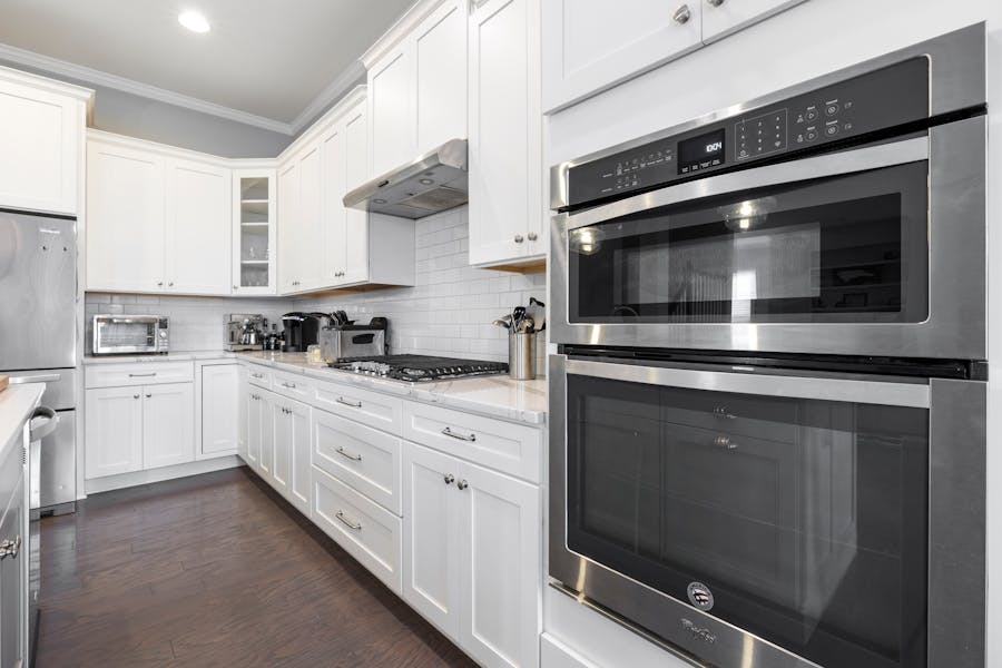Stainless-steel built-in wall oven with microwave above in a modern Toronto kitchen