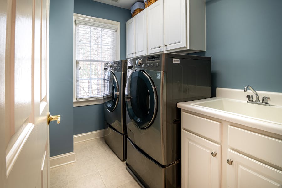 Modern front-load washing machine and dryer in a Toronto home laundry room